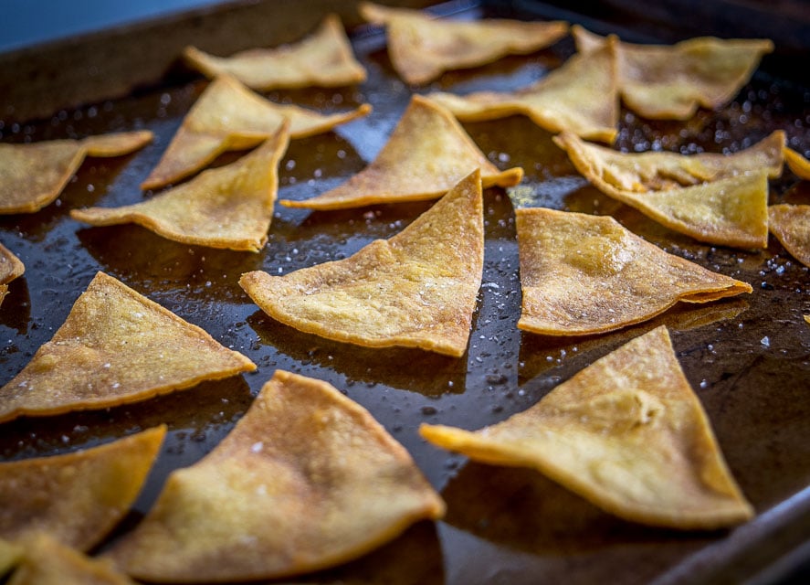 This is the easiest way to make a batch of Baked Tortilla Chips. I like them best when the edges are crispy but the middle is still slightly chewy, i.e. don't cook them too long! mexicanplease.com