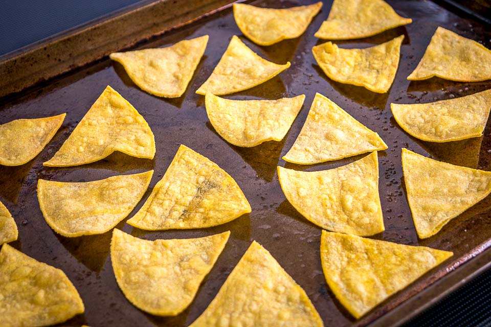 This is the easiest way to make a batch of Baked Tortilla Chips. I like them best when the edges are crispy but the middle is still slightly chewy, i.e. don't cook them too long! mexicanplease.com