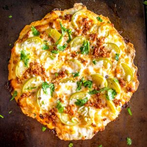 This is my new favorite pizza! The pickled tomatillos pair well with the chorizo and we're using a garlic oil layer as the sauce -- so good! mexicanplease.com