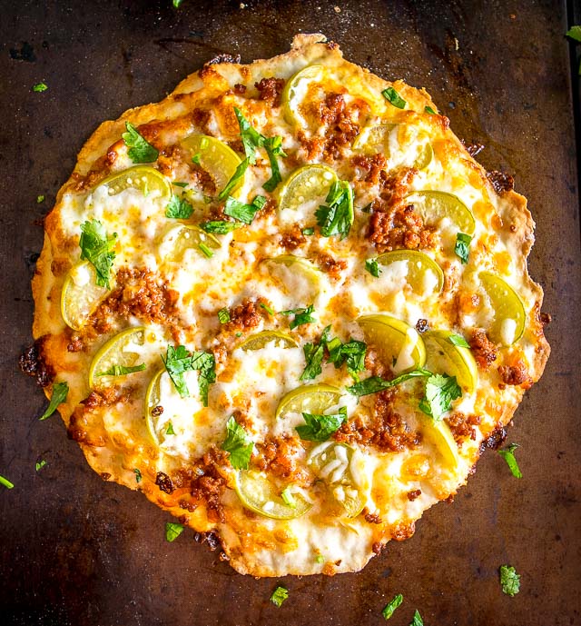 This is my new favorite pizza! The pickled tomatillos pair well with the chorizo and we're using a garlic oil layer as the sauce -- so good! mexicanplease.com