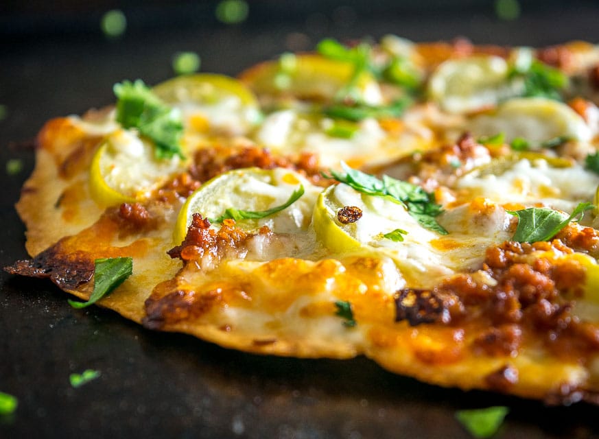 This is my new favorite pizza! The pickled tomatillos pair well with the chorizo and we're using a garlic oil layer as the sauce -- so good! mexicanplease.com