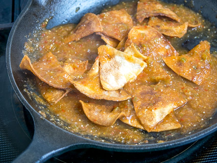 coating baked tortilla chips with salsa