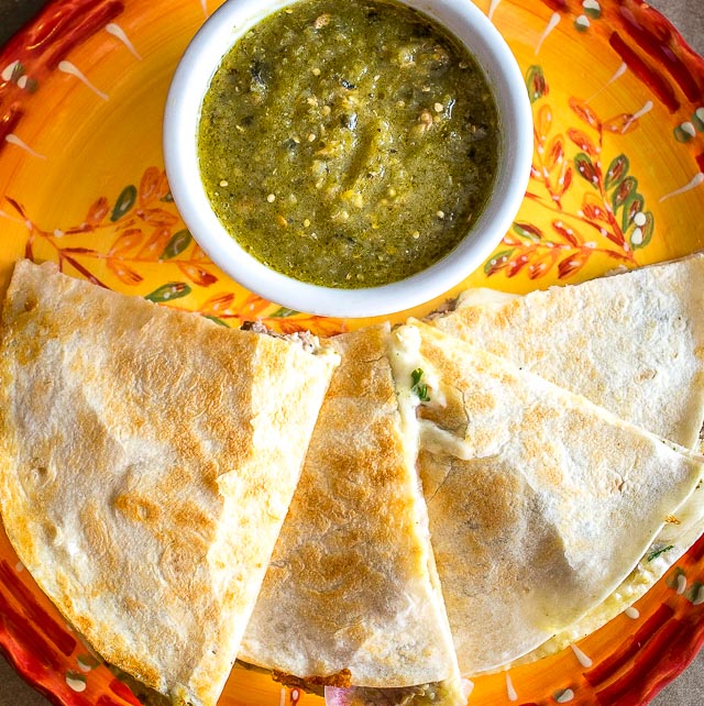 As promised, here are the quesadillas I've been making with my leftover Chili Verde. I used some homemade pickled onions for this batch and they are delicious! mexicanplease.com
