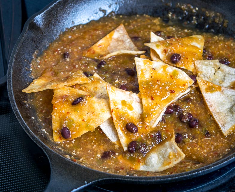 Adding warm Salsa to the tortilla pieces