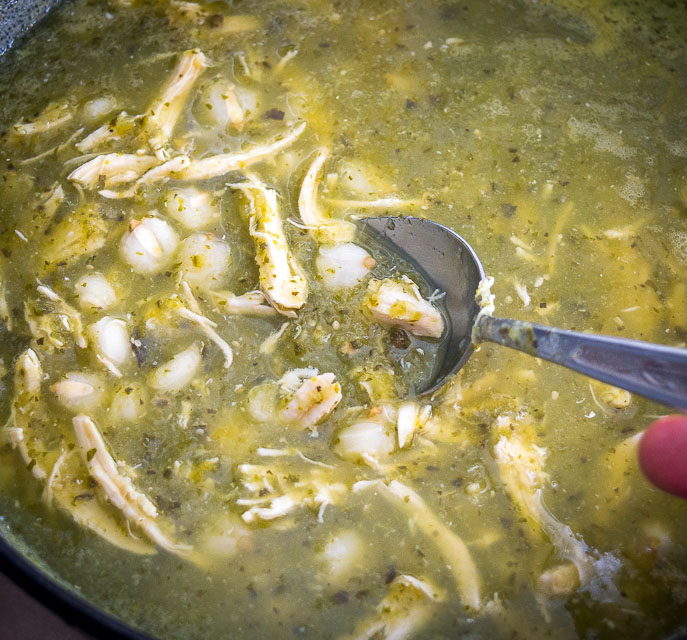 Adding more hominy to Pozole Verde