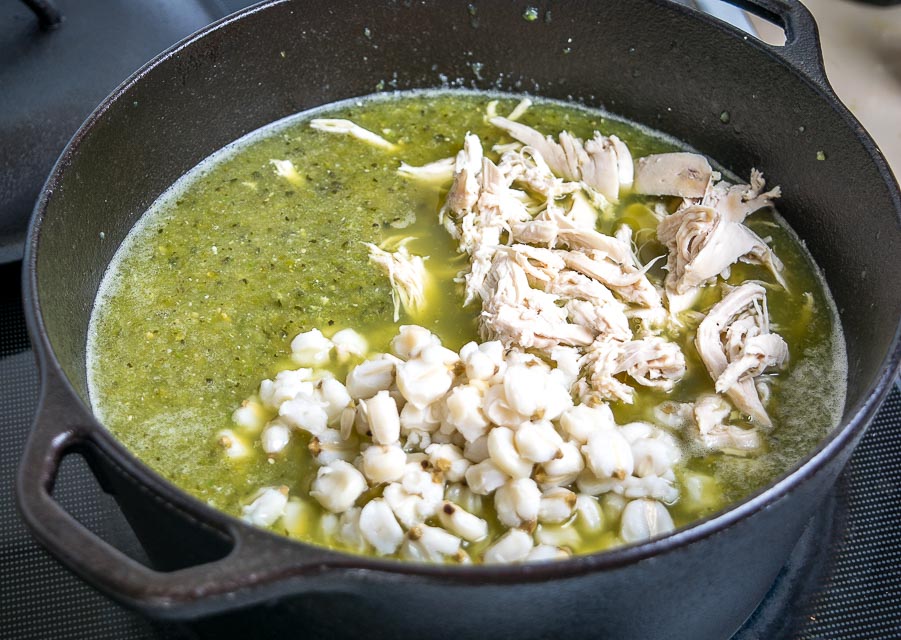 Adding shredded chicken and hominy to Pozole Verde