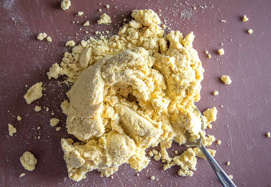 Kneading masa dough into a cohesive ball.