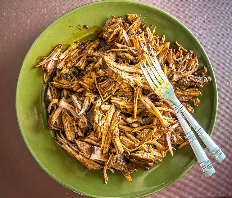 3 lbs. beef brisket shredded after simmering in enchilada sauce