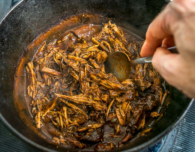 Adding enchilada sauce to the Shredded Beef.