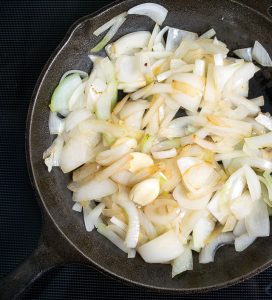 Saute onion and garlic for enchilada sauce.