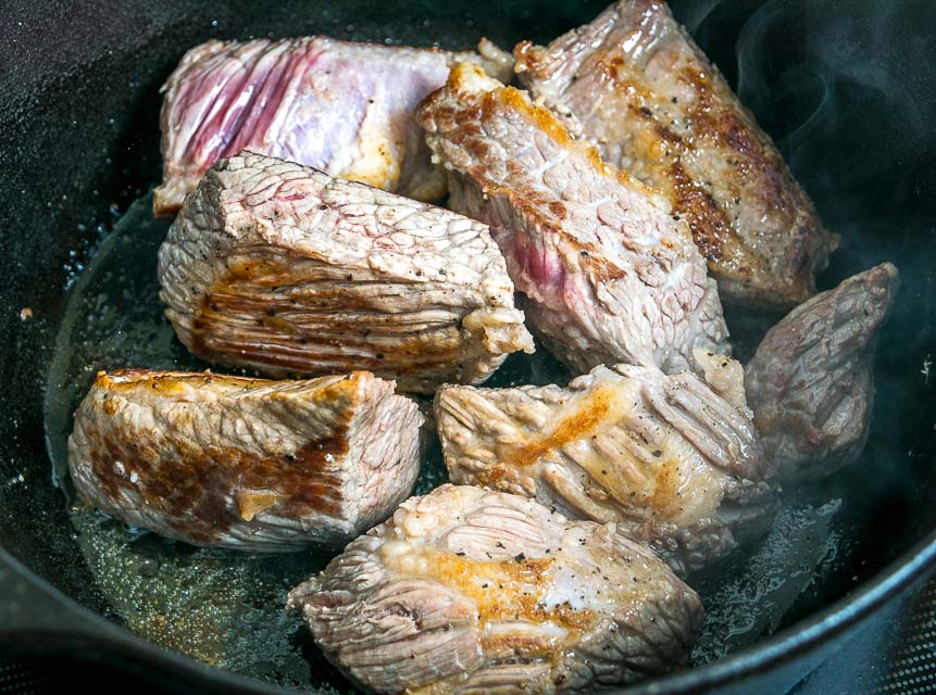 Browning beef brisket in Dutch oven.