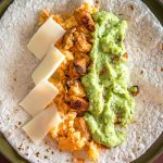 Put some Avocado Salsa Verde in your burritos and everything beyond that is a bonus! I added chicken, Mexican rice, and cheese to this batch -- yum!! mexicanplease.com