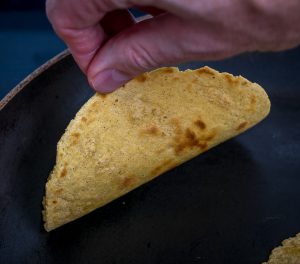 Light brown spots forming on tortillas.