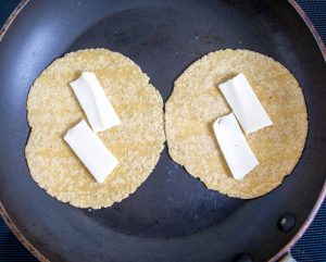Melting cheese in tortillas in a dry skillet.