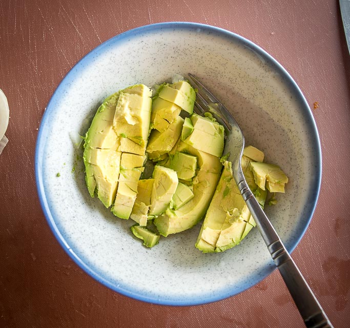 Making guacamole. 