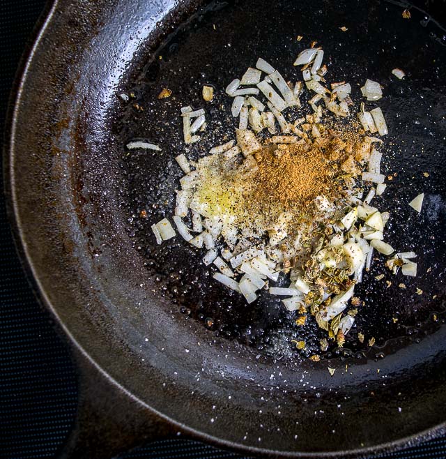 adding spices to the adobo sauce