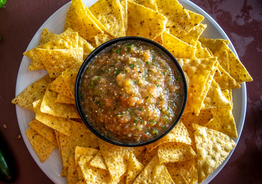 Serving roasted tomato and tomatillo salsa with chips.