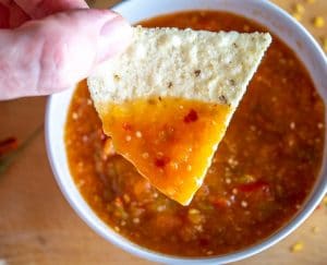 Dipping a chip in Chile de Arbol Salsa