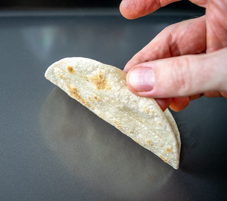 Checking bottom of tortilla for light brown spots