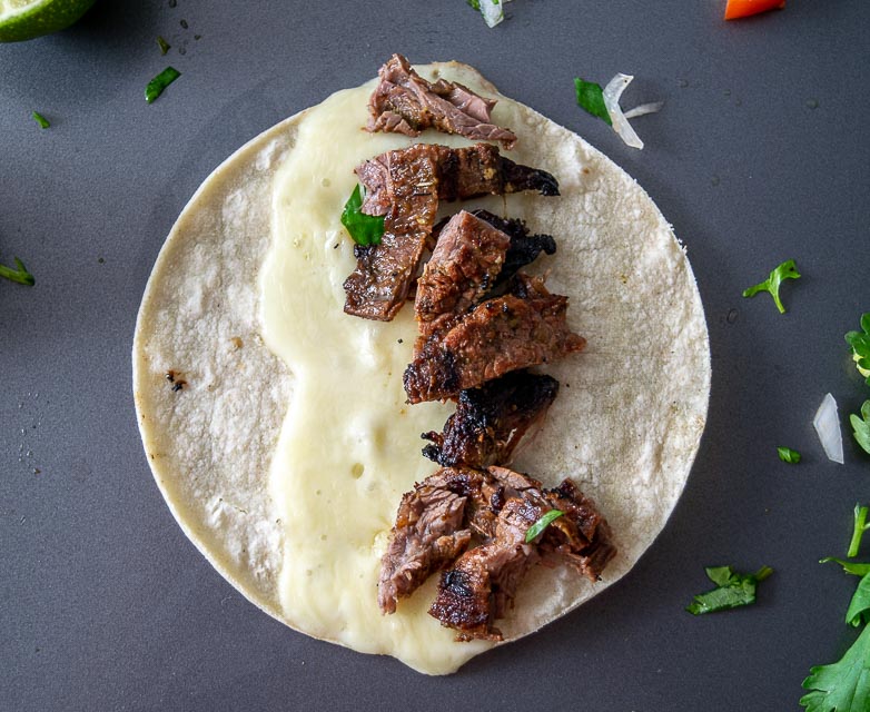 Chopping up skirt steak into bite sized pieces