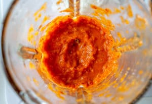 Combining tomatoes and chipotles in the blender for Queso Dip