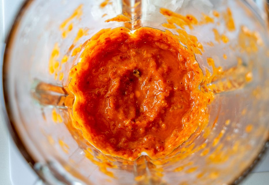 Combining tomatoes and chipotles in the blender for Queso Dip