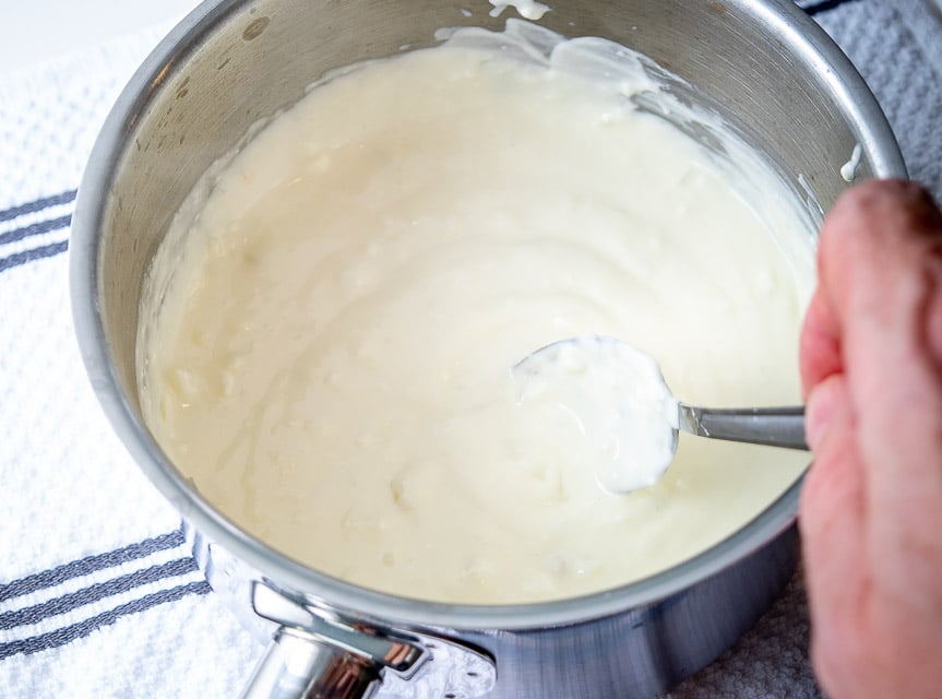 Taking a taste of the Queso before adding chipotles