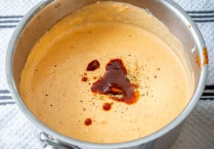 Adding adobo sauce to the Queso Dip