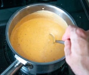 Stirring Queso Dip on stove