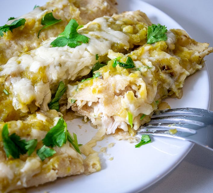 Taking a bite of Hatch green chile enchiladas