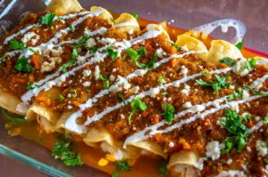 Here's an easy recipe for a wicked batch of Chicken Tinga Enchiladas -- be sure to add tomatillos to the Tinga sauce as it makes a huge difference! mexicanplease.com