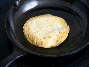 Using cast iron pan to fry tortillas