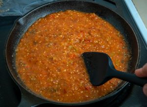 Adding Mexican oregano to the Tinga sauce