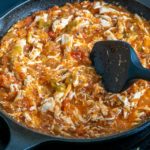 Adding shredded chicken to the Tinga sauce