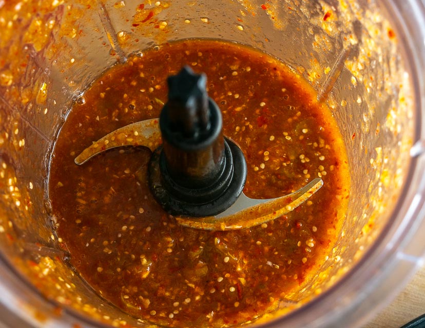 Blending together tomatillos and chipotles