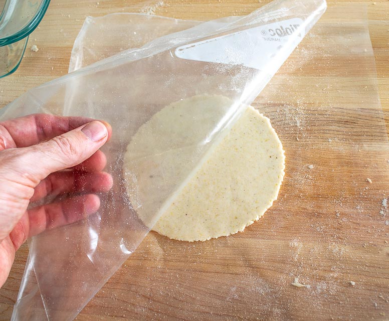 Peeling plastic off flattened dough ball