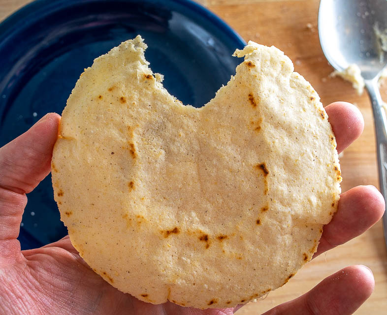 Taking a bite from homemade corn tortilla