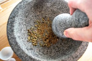 Grinding up the spices in a molcajete