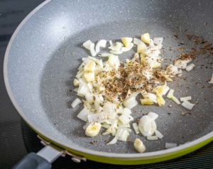 Adding spice mixture to the onion and garlic