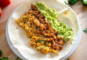 Cheese, chicken, guacamole, and Mexican rice for burritos