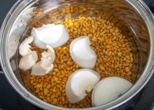 Adding lard and onion to the pot beans
