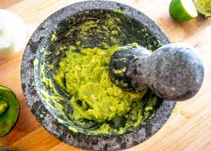 Batch of Guacamole after grinding an unripe avocado