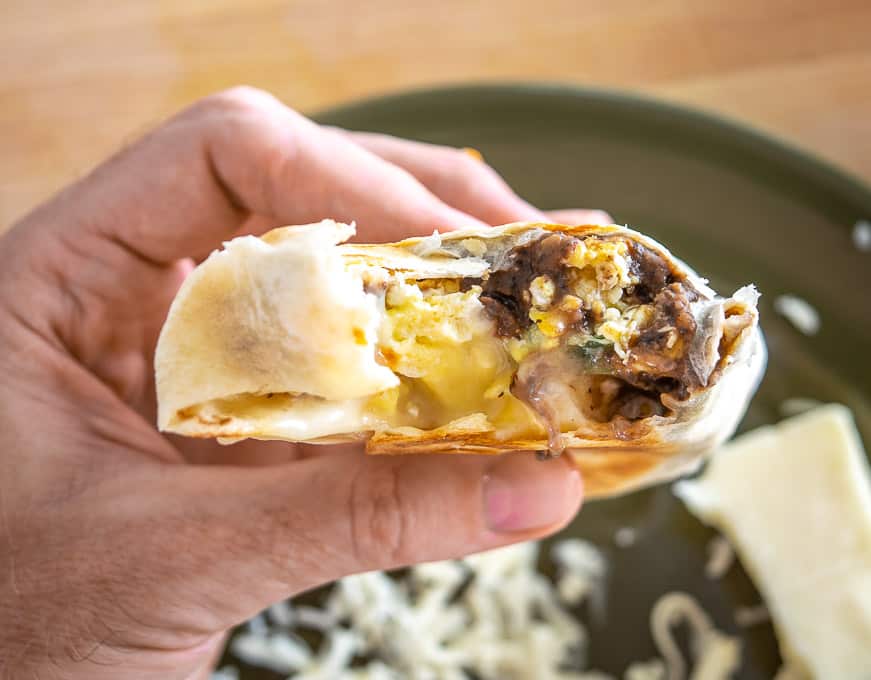 Taking a bite of the breakfast burrito