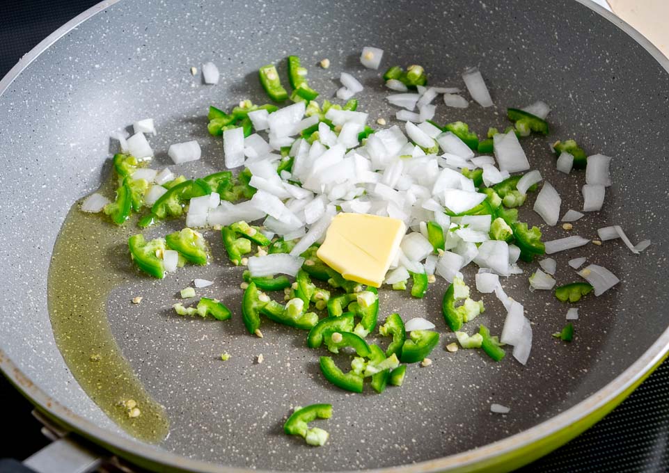 Cooking onion and jalapeno in some oil and butter