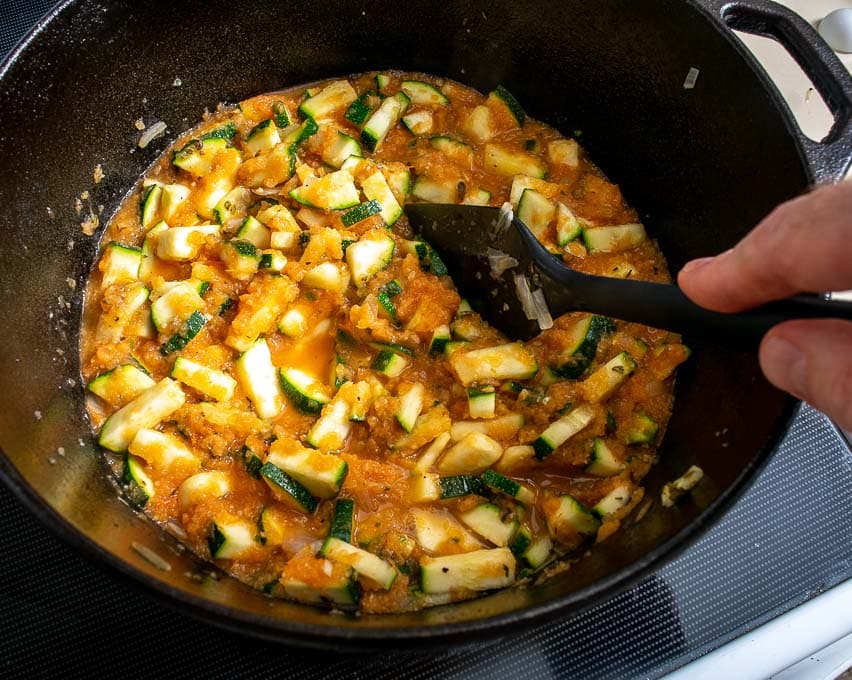 door het tomatenmengsel aan de courgette toe te voegen