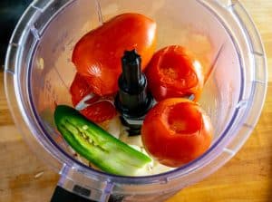 Adding sliver of jalapeno to the tomato mixture