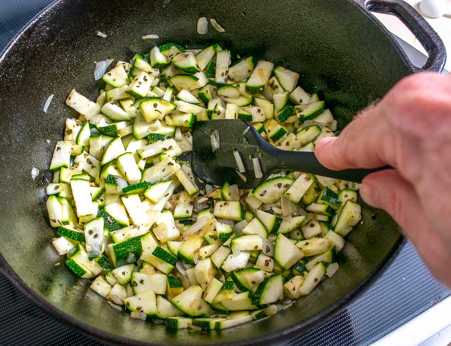 Adding chopped zucchini to the stock pot
