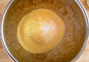 Combining masa harina and salt in a mixing bowl