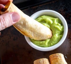Dipping Beef Taquito in some Salsa de Aguacate