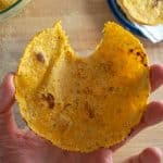 Taking a bite of corn tortilla after cooking